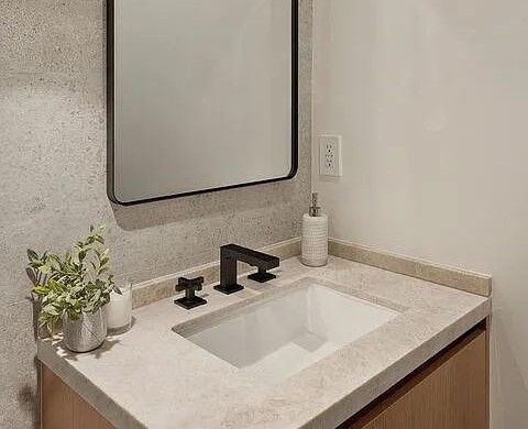 Powder room with oak vanity and fluted pendant